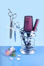 Hairdressing set of scissors and brushes on a blue background
