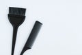 Hairdressing tools. Plastic black comb and brush for coloring hair on white background Royalty Free Stock Photo