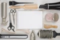 Hairdressing tools on wooden background with blank sheet in centre