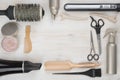 Hairdressing tools on wooden background with copyspace in the middle