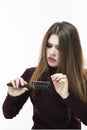 Hairloss and Baldness Issues. Young Caucasian Female Having Hair Problems. Checking Hair in Hairbrush. Against White Royalty Free Stock Photo