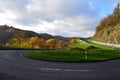 hairpin curve of a country road with a car approaching from the top Royalty Free Stock Photo