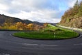 hairpin curve of a country road with a car approaching from the valley Royalty Free Stock Photo