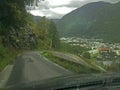 Hairpin curve on a steep road photographed from inside a car through the front window. Royalty Free Stock Photo