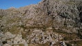 Hairpin turn road between rocky mountains. MA-2141 road, way to Sa Calobra village, Majorca. Aerial drone 4K