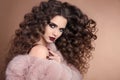 Hairstyle. Beauty hair. Fashion brunette girl with long curly ha Royalty Free Stock Photo