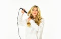 Hairstyle And Hairdressing. girl curling long hair with curler. Girl care about her hairstyle. woman curling hair with Royalty Free Stock Photo