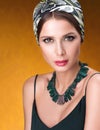 Hairstyle with headscarf. Portrait of young beautiful woman with necklace Royalty Free Stock Photo