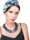 Hairstyle with headscarf. Portrait of young beautiful woman with necklace Royalty Free Stock Photo