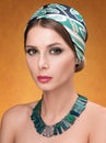 Hairstyle with headscarf. Portrait of young woman with necklace Royalty Free Stock Photo