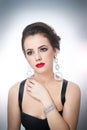 Hairstyle and make up - beautiful female art portrait with beautiful eyes. Elegance. Genuine natural brunette with jewelry Royalty Free Stock Photo