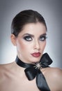Hairstyle and Make up - beautiful female art portrait with black ribbon. Elegance. Genuine Natural brunette with ribbon - studio