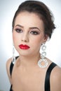 Hairstyle and make up - beautiful female art portrait with earrings. Elegance. Genuine natural brunette with jewelry Royalty Free Stock Photo