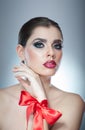 Hairstyle and Make up - beautiful female art portrait with red ribbon. Elegance. Genuine Natural brunette with ribbon - studio