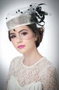 Hairstyle and make up - beautiful young girl art portrait. Cute brunette with white cap and veil, studio shot. Attractive girl