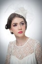 Hairstyle and make up - beautiful young girl art portrait. Cute brunette with white cap and veil, studio shot. Attractive girl