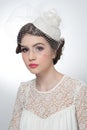 Hairstyle and make up - beautiful young girl art portrait. Cute brunette with white cap and veil, studio shot. Attractive girl