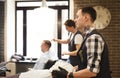 Man getting haircut by hairstylist at barbershop