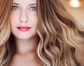 Hairstyle model and beauty face closeup. Beautiful blonde woman with long straight blond hair styled in curly waves Royalty Free Stock Photo