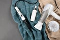 Hairstyling tools (white hairdryer, hairspray, cone curling wand