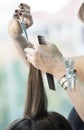 Hairstylist cutting hair of female customer
