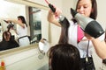 Hairstylist drying hair woman client in hairdressing beauty salon Royalty Free Stock Photo