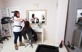 Hairstylist drying hair woman client in hairdressing beauty salon