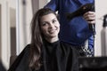 Hairstylist drying woman's hair