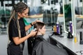 hairstylist spraying hair of female client Royalty Free Stock Photo