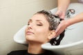 Hairstylist washing woman hair. Hairdressing beauty salon Royalty Free Stock Photo