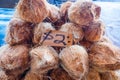 Hairy brown coconuts in husks for sale at Fugalei fresh produce Royalty Free Stock Photo