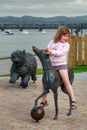 Girl riding on `Hairy Maclary` dog sculpture, Tauranga, New Zealand