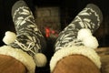 Hairy male feet in woolen warm socks Royalty Free Stock Photo