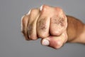 Hairy man fist closeup expression over gray Royalty Free Stock Photo