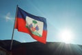 Haitian flag with sunset casting rays of light