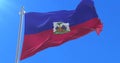 Flag of Haiti waving at wind with blue sky, loop