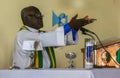 Haitian priest offers up the host at mass in rural Haiti.