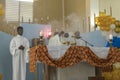 Haitian priest incences the altar during mass in rural northern Haiti.