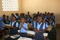 Haitian school children welcome visitors in their classroom.