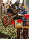 Haitian women work on an old sewing machines.