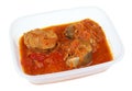 Hake fish stewed with vegetables in a plastic box isolated