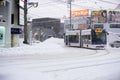 Modern and electric trams run in urban and heavy snowfall.