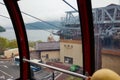 View of Togendai Station and pirate ship on pier at Lake Ashi from Hakone sightseeing tour cable car window.
