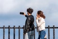 HAKONE, JAPAN - NOVEMBER 5, 2017: Young couple doing selfie on a background of mountains. Copy space for text. Royalty Free Stock Photo