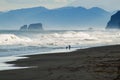 Halaktyr beach. Kamchatka. Russian federation. Dark almost black color sand beach of Pacific ocean. Stone mountains and Royalty Free Stock Photo