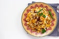 Halal Indian chicken Biryani served with yogurt tomato raita over white background. Selective focus. Top view