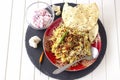 Halal Indian chicken or mutton Biryani served with yogurt tomato raita and crispy pappadam. White background. Selective focus Royalty Free Stock Photo