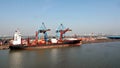 Haldia, India, October, 27, 2020. Seagoing vessels, tugboats at the port under cargo operations and underway.