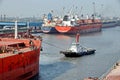 Haldia, India, October, 27, 2020. Seagoing vessels, tugboats at the port under cargo operations and underway.