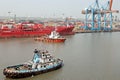 Haldia, India, October, 27, 2020. Seagoing vessels, tugboats at the port under cargo operations and underway.